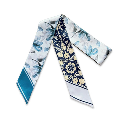 Elegant personalized twilly scarf with intricate ornamental floral design in navy, ivory, and soft blue hues.