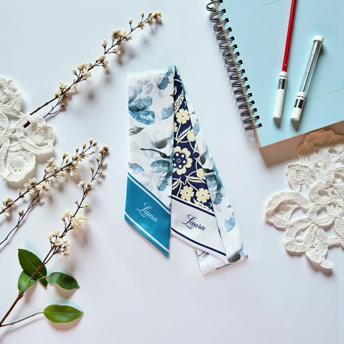 Double-sided satin twilly scarf with navy baroque floral pattern and delicate blue botanical print.