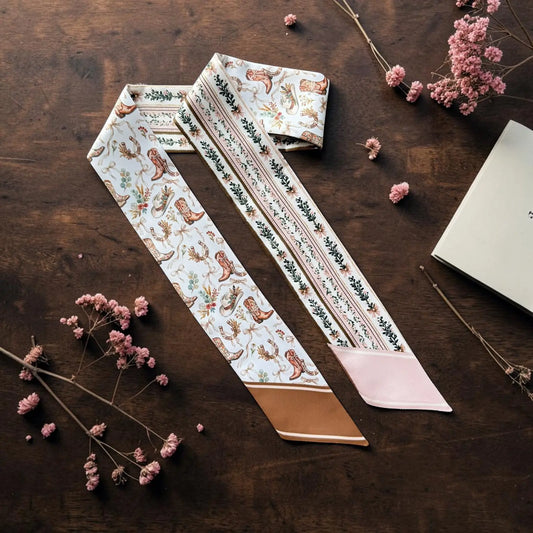 Western-inspired skinny scarf with cowgirl boots and hats, floral pattern in soft pink and brown 