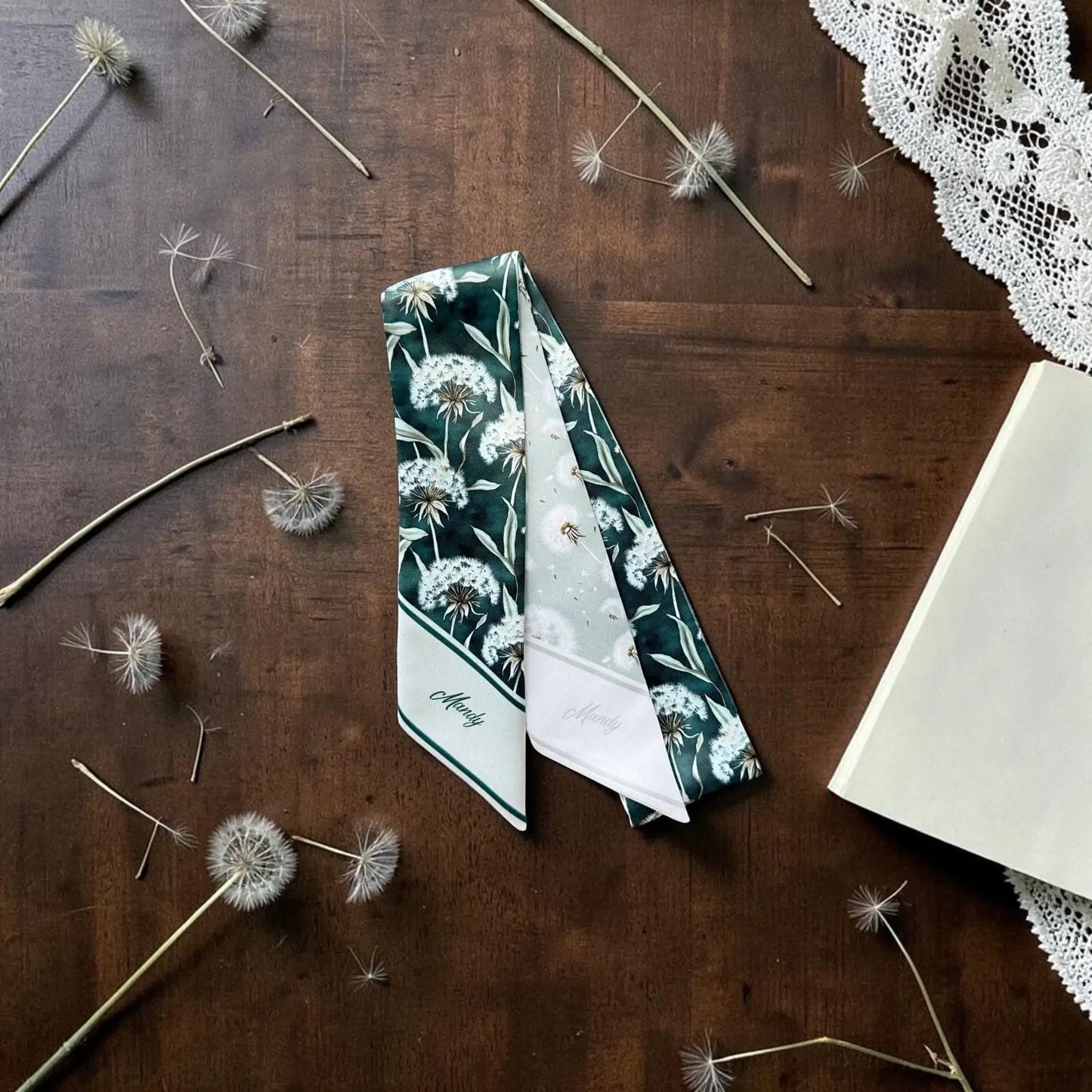 Botanical skinny scarf featuring airy dandelion print in natural sage tones
