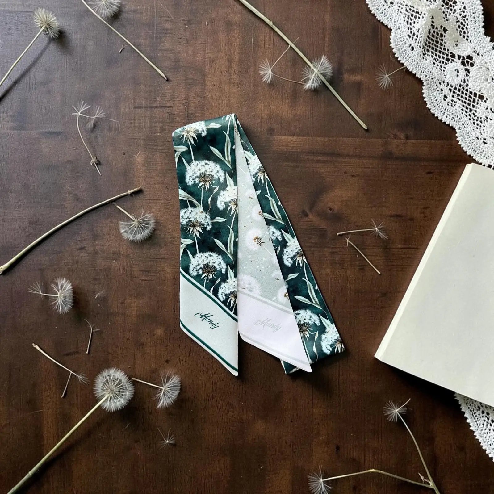 Botanical skinny scarf featuring airy dandelion print in natural sage tones