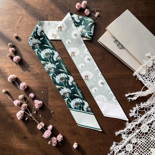 Sage green skinny scarf with delicate white dandelion botanical pattern