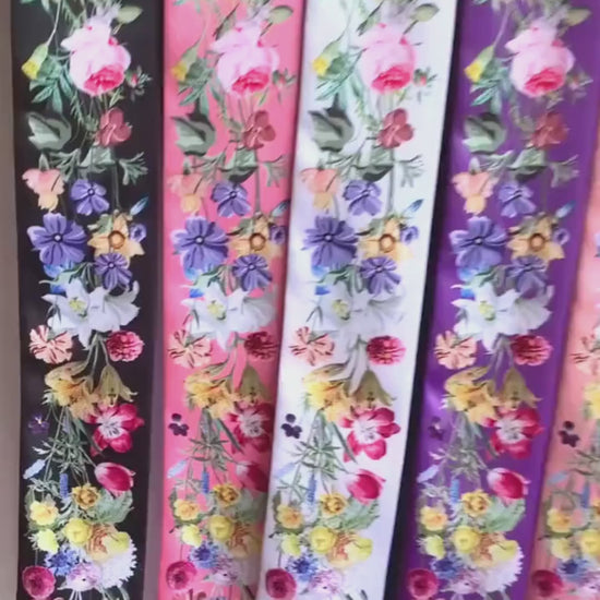 Video showcasing personalised floral twilly scarves featuring vibrant watercolour wildflowers in different colours and custom name options.