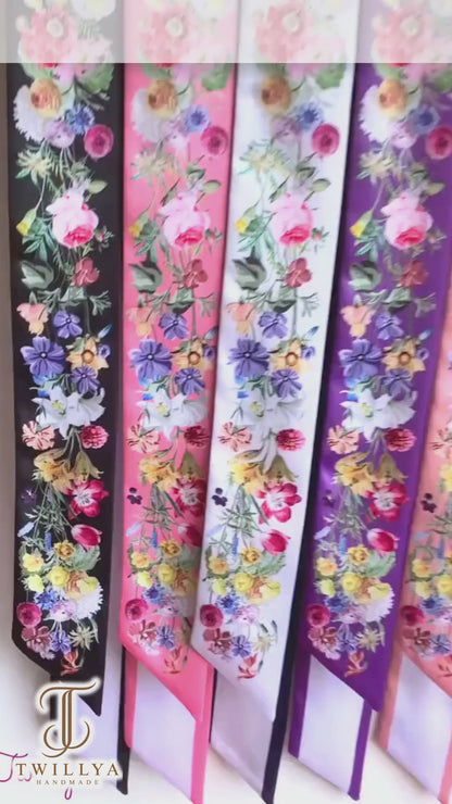 Video showcasing personalised floral twilly scarves featuring vibrant watercolour wildflowers in different colours and custom name options.