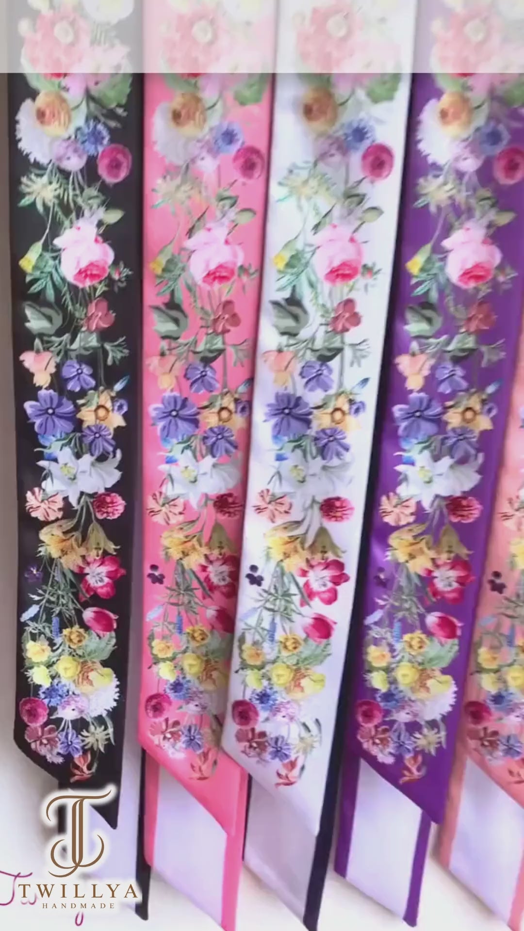 Video showcasing personalised floral twilly scarves featuring vibrant watercolour wildflowers in different colours and custom name options.