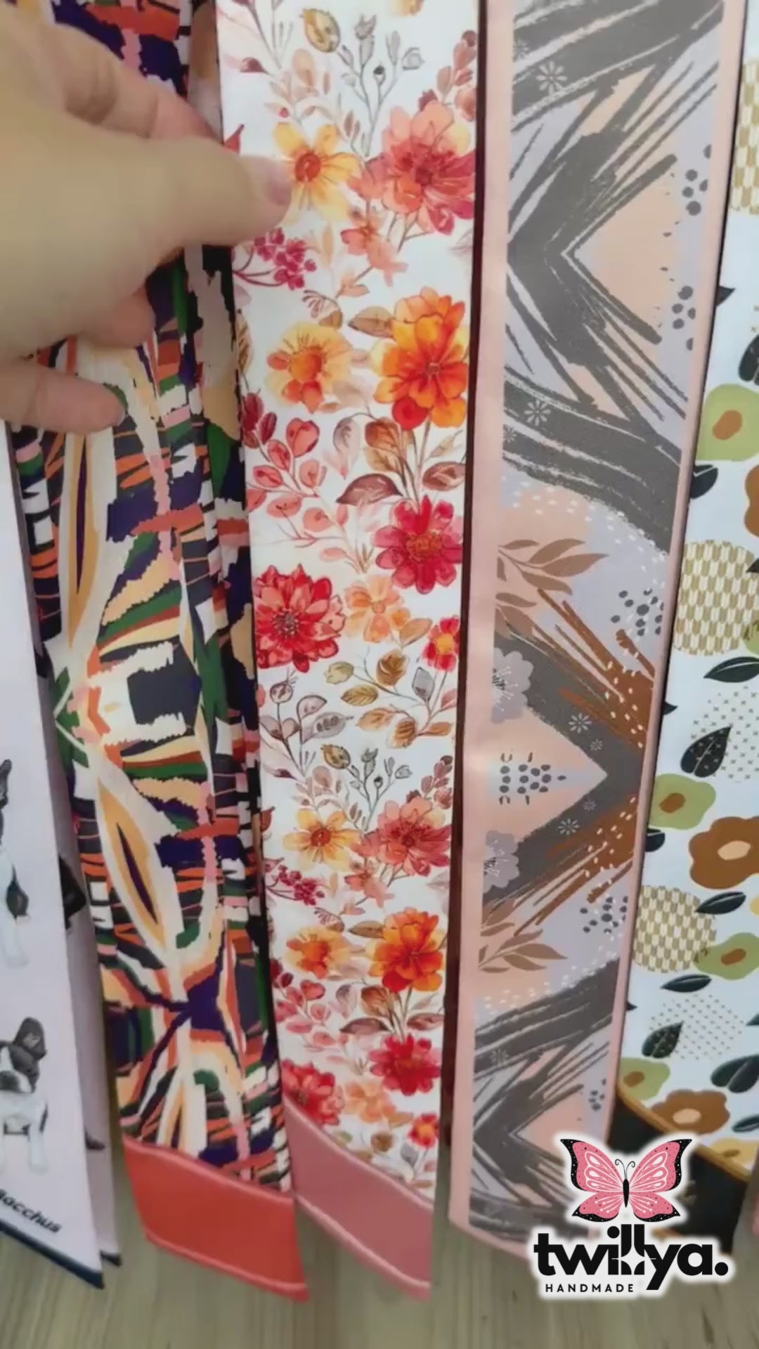Video showing Amber twilly scarf with delicate floral pattern in orange and cream tones