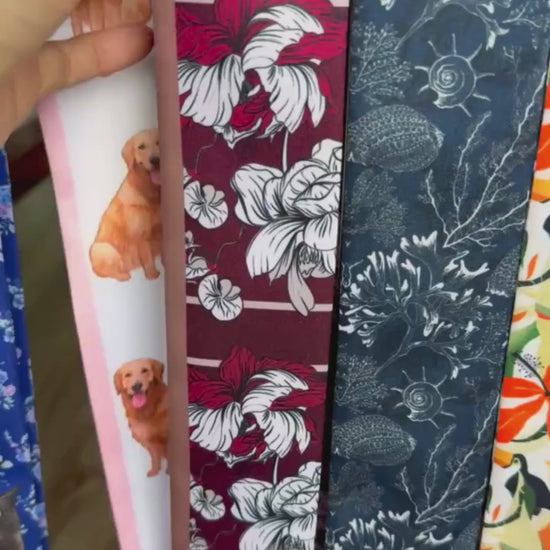 Video showcasing a maroon floral twilly scarf featuring oversized ivory and blush pink botanical flowers, a contrasting pink reverse side, and an elegant vintage-inspired design.