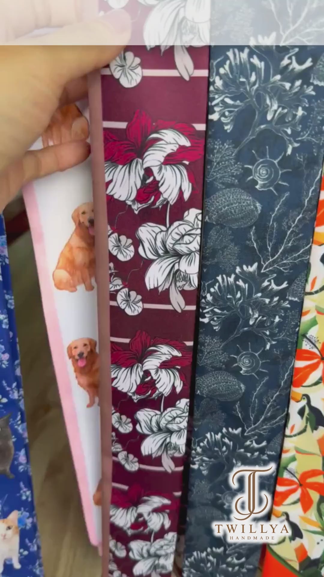 Video showcasing a maroon floral twilly scarf featuring oversized ivory and blush pink botanical flowers, a contrasting pink reverse side, and an elegant vintage-inspired design.