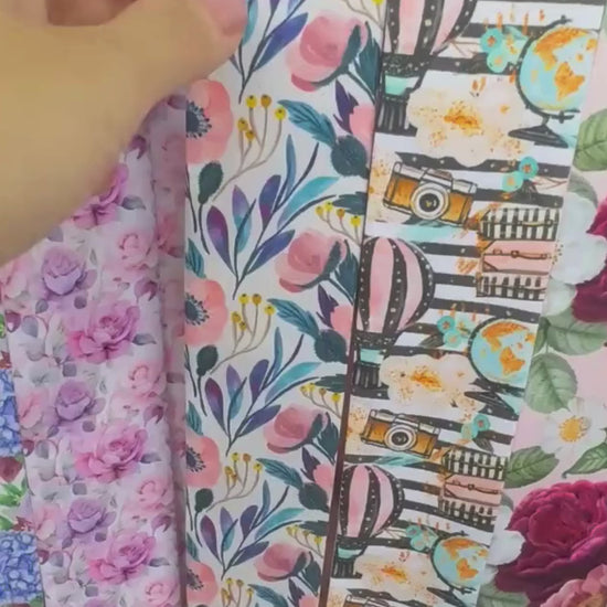 Close-up video of a personalized satin skinny scarf featuring elegant ornamental floral patterns and soft blush pink detailing, highlighting its luxurious texture and double-sided design.