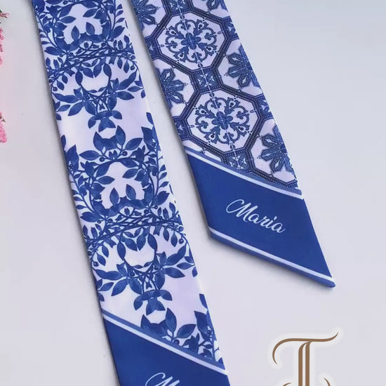Video showcasing a blue and white Chinoiserie twilly scarf featuring porcelain-inspired tile patterns and elegant botanical foliage.