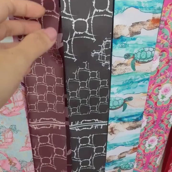 Video of skinny twilly scarf featuring abstract geometric shapes and stripe accents in monochrome color 