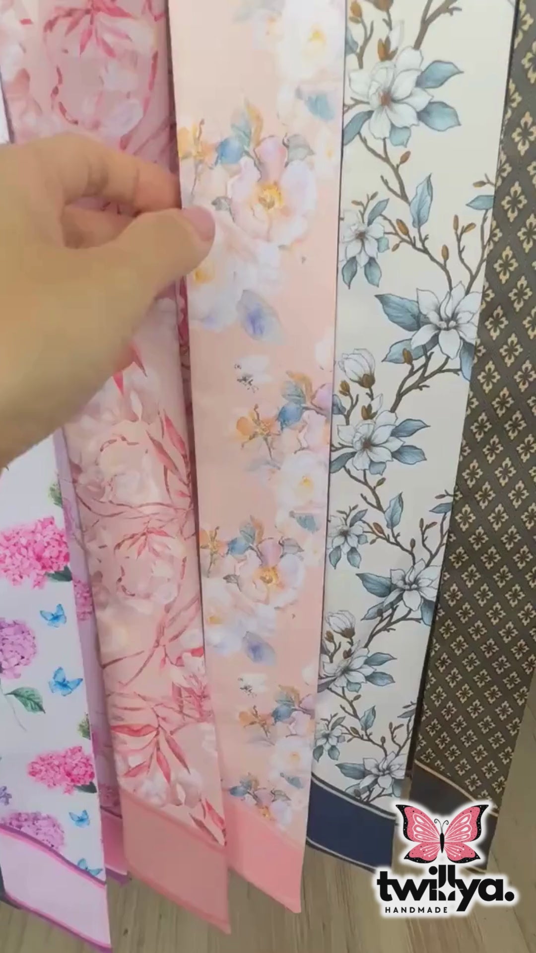 Video showing elegant twilly scarf with pastel floral design in blush pink and blue colours