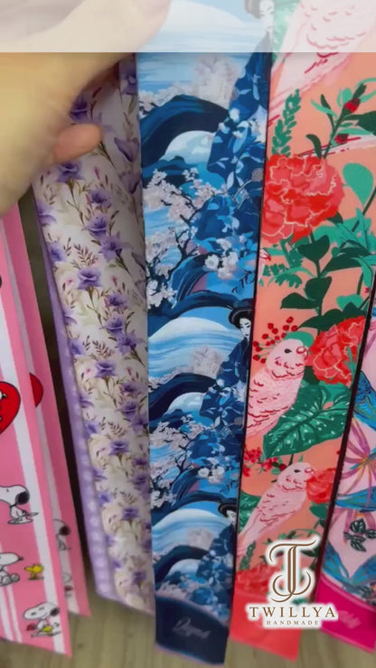 Personalized Japanese-inspired twilly scarf showcasing delicate cherry blossoms, flowing blue waves, navy and pink accents, and custom name details. A versatile skinny scarf for handbags, hair styling, and gifting.