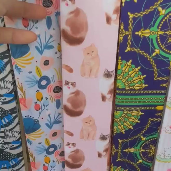 Video showing a pastel cat lovers twilly scarf with playful illustrated cats in pink, cream and orange colourways.
