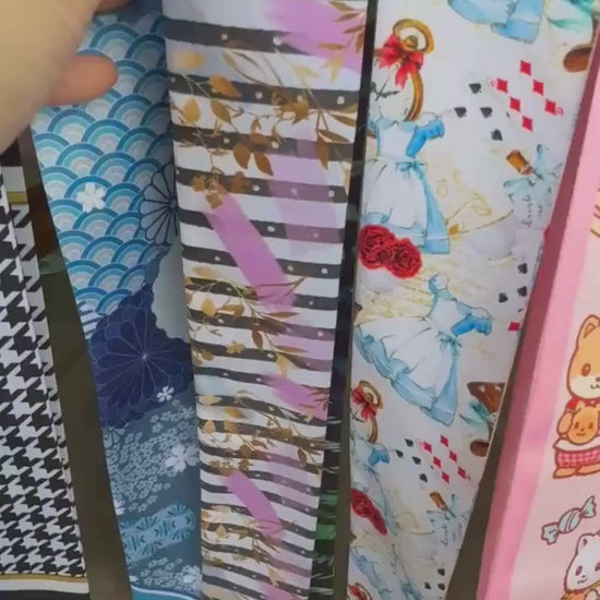 Video showing double-sided twilly scarf with abstract leaf and striped pattern in modern colours