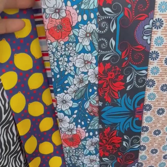 Colourful floral twilly scarf showcasing contrasting coral red and blue botanical patterns, delicate white and pink flowers, and custom name details. A versatile skinny scarf for handbags, hair styling, and personalized gifting.