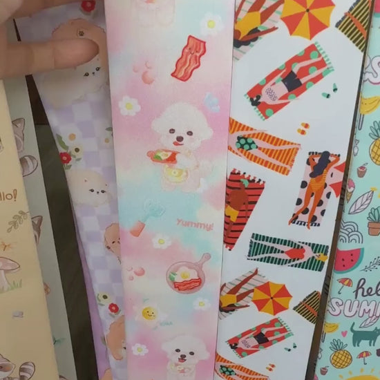 Video showing pastel Bichon dog twilly scarves with breakfast motifs and different colour options
