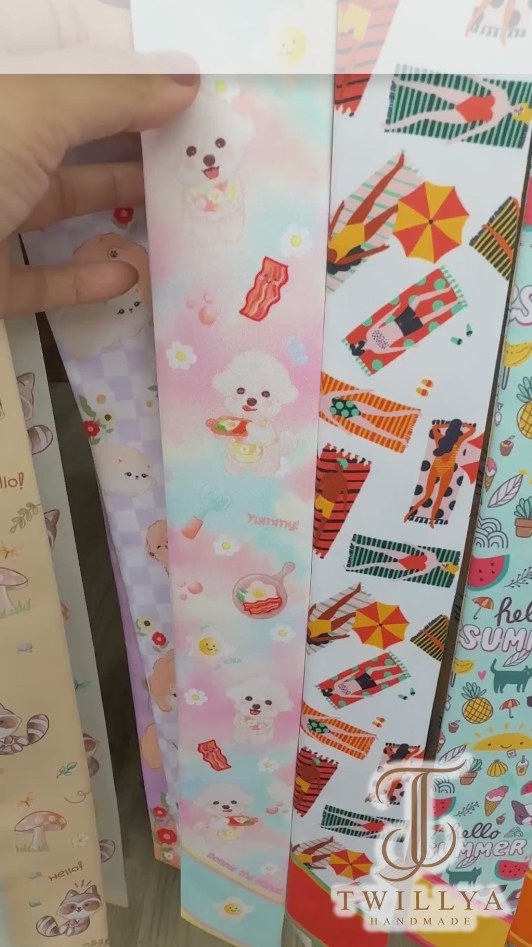 Video showing pastel Bichon dog twilly scarves with breakfast motifs and different colour options