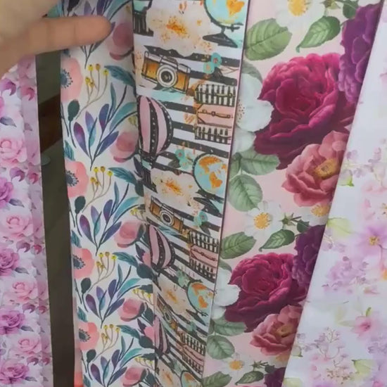 Close-up video of a personalized satin skinny scarf featuring whimsical travel-inspired illustrations, soft pastel abstract patterns, and a luxurious double-sided silky finish.