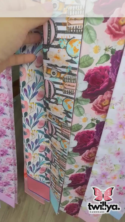 Close-up video of a personalized satin skinny scarf featuring whimsical travel-inspired illustrations, soft pastel abstract patterns, and a luxurious double-sided silky finish.