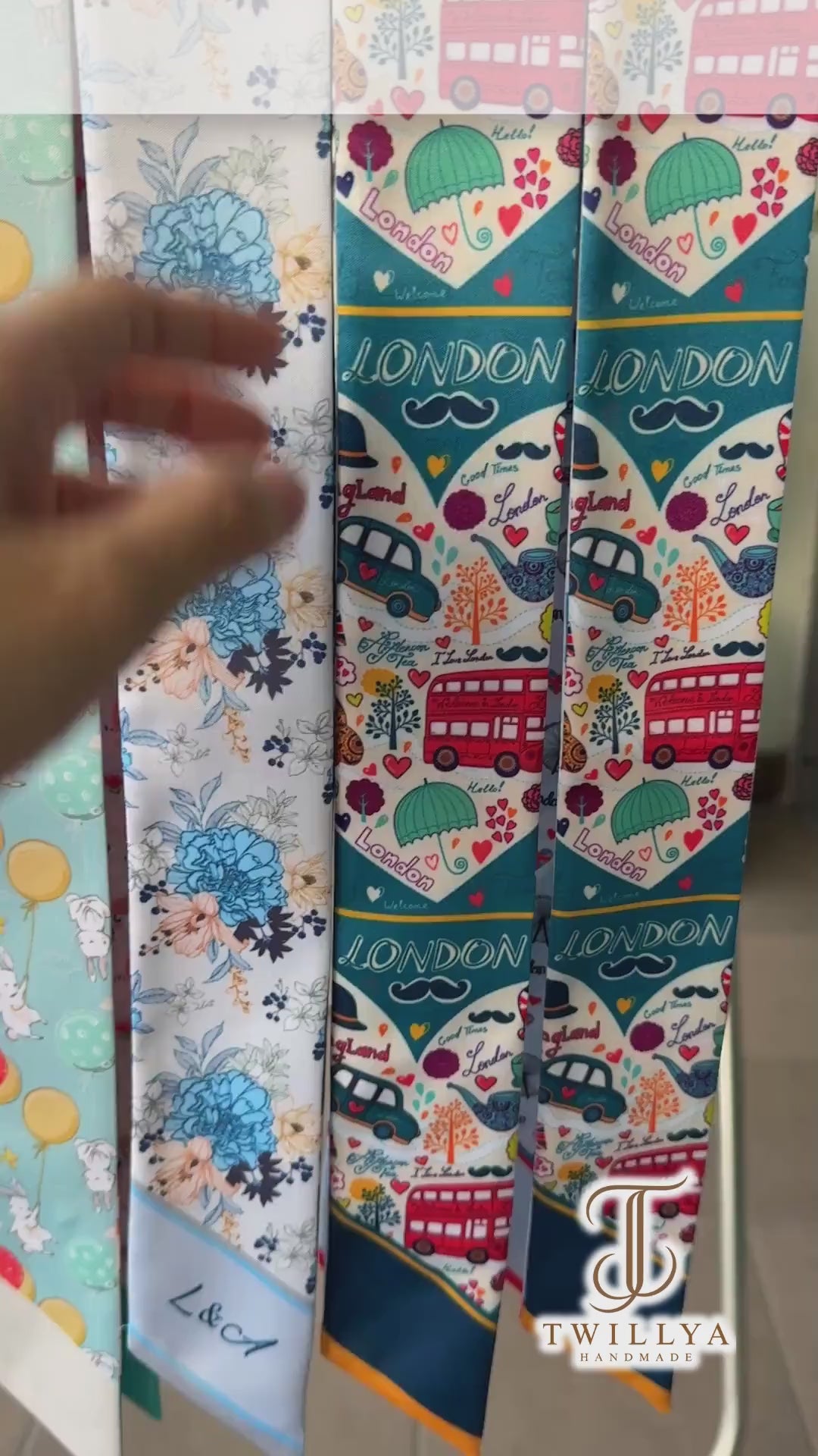London-themed twilly scarf showcasing iconic red double-decker buses, Big Ben, the London Eye, telephone booths, black taxis, and colorful travel illustrations. A versatile skinny scarf for handbags, hair styling, and gifts for London lovers.