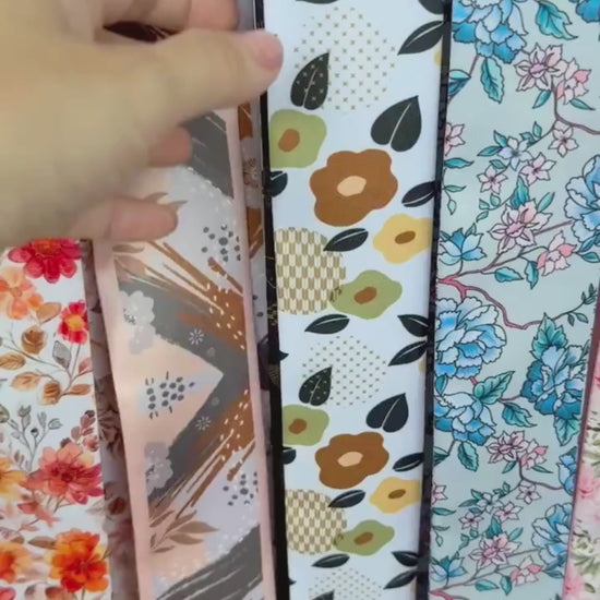Video showing double-sided twilly scarf with floral and geometric design in brown and orange colors