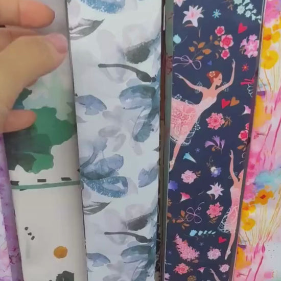 Close-up video of a personalized satin skinny scarf featuring elegant blue ornamental floral patterns and soft botanical detailing, showcasing its luxurious double-sided design and silky texture.