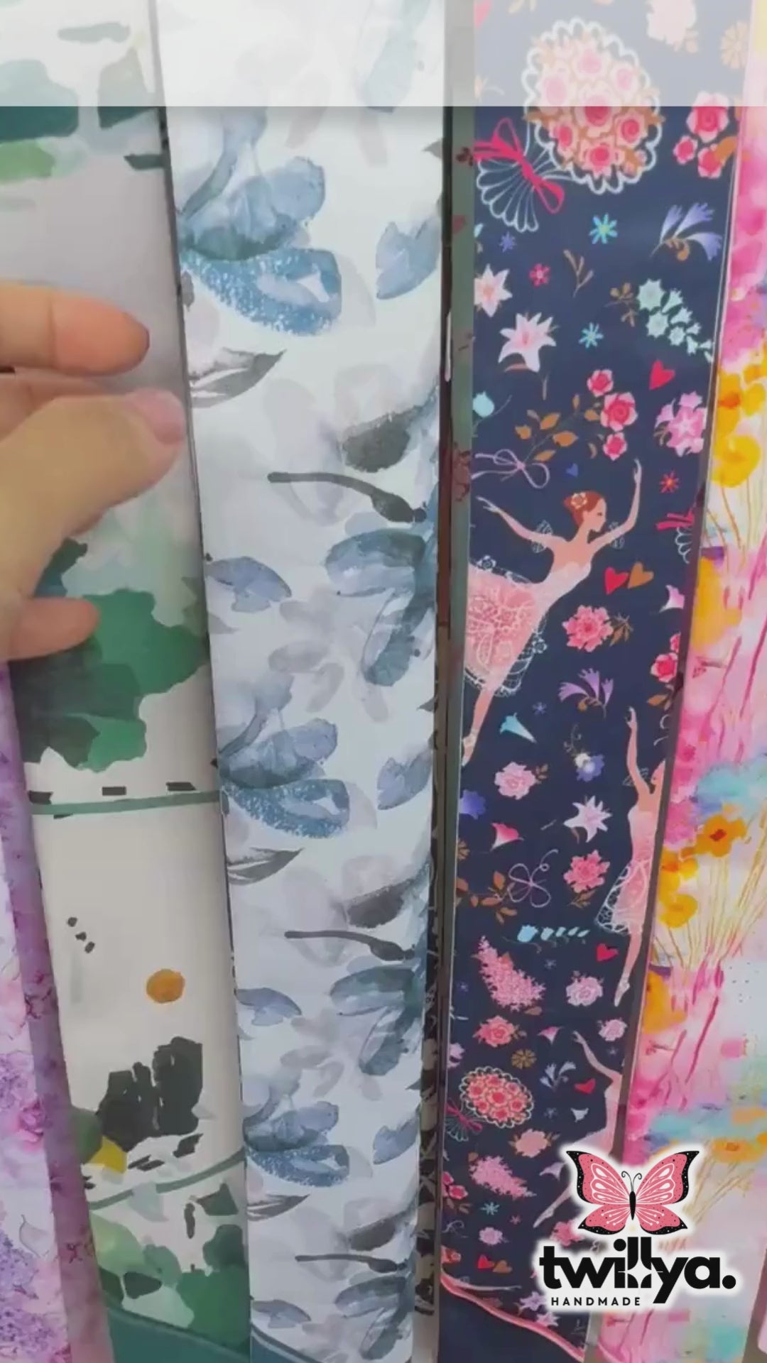 Close-up video of a personalized satin skinny scarf featuring elegant blue ornamental floral patterns and soft botanical detailing, showcasing its luxurious double-sided design and silky texture.